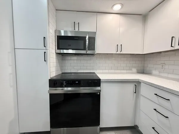 a kitchen with a stove and a microwave