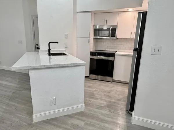 a kitchen with a sink a stove and refrigerator
