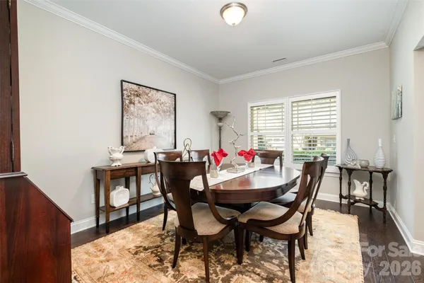 a view of a dining room with furniture and a window