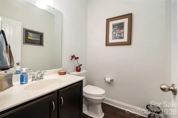 a bathroom with a sink mirror and toilet