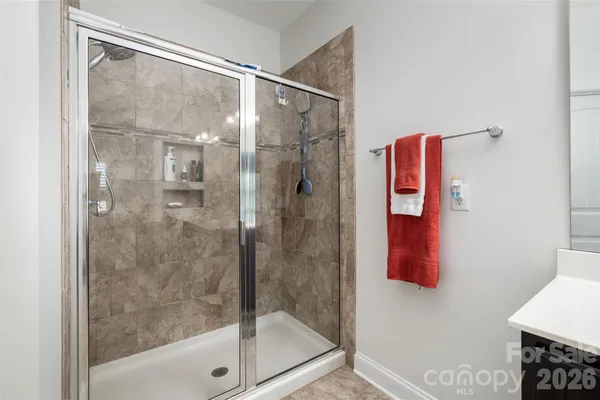 a bathroom with a shower and a bath tub