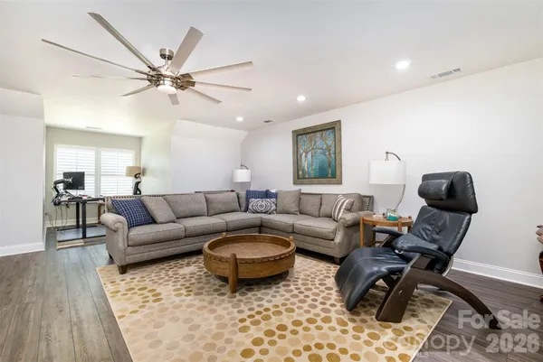 a living room with furniture a rug and a window