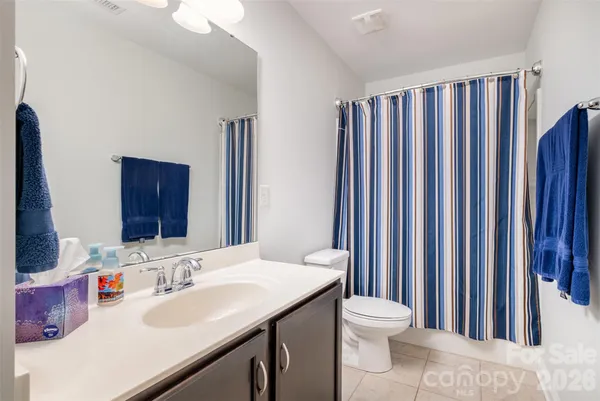 a bathroom with a sink a toilet and mirror