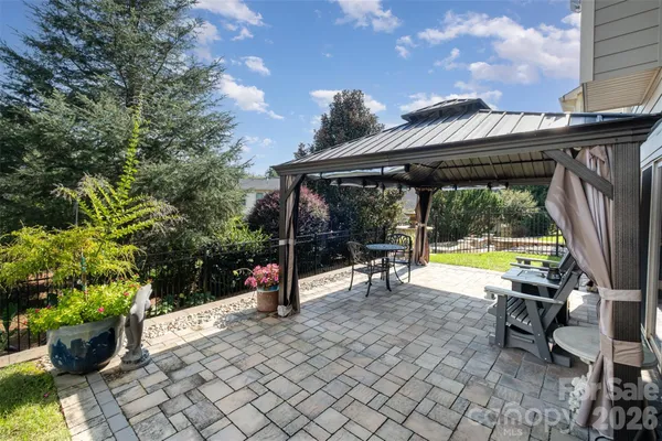 a view of a house with backyard porch and sitting area