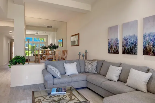 a living room with furniture and a large mirror
