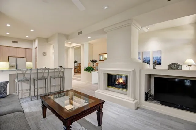 a living room with furniture a fireplace and a table