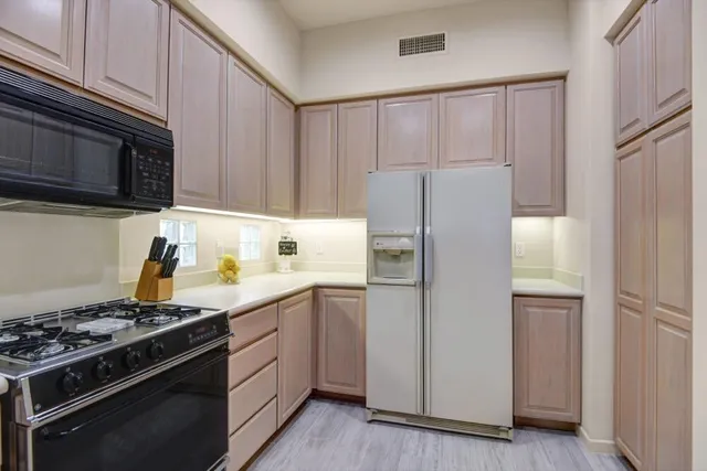a kitchen with a stove and a refrigerator