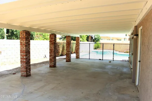 a view of a backyard with table and chairs