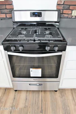 a stove top oven sitting inside of a kitchen