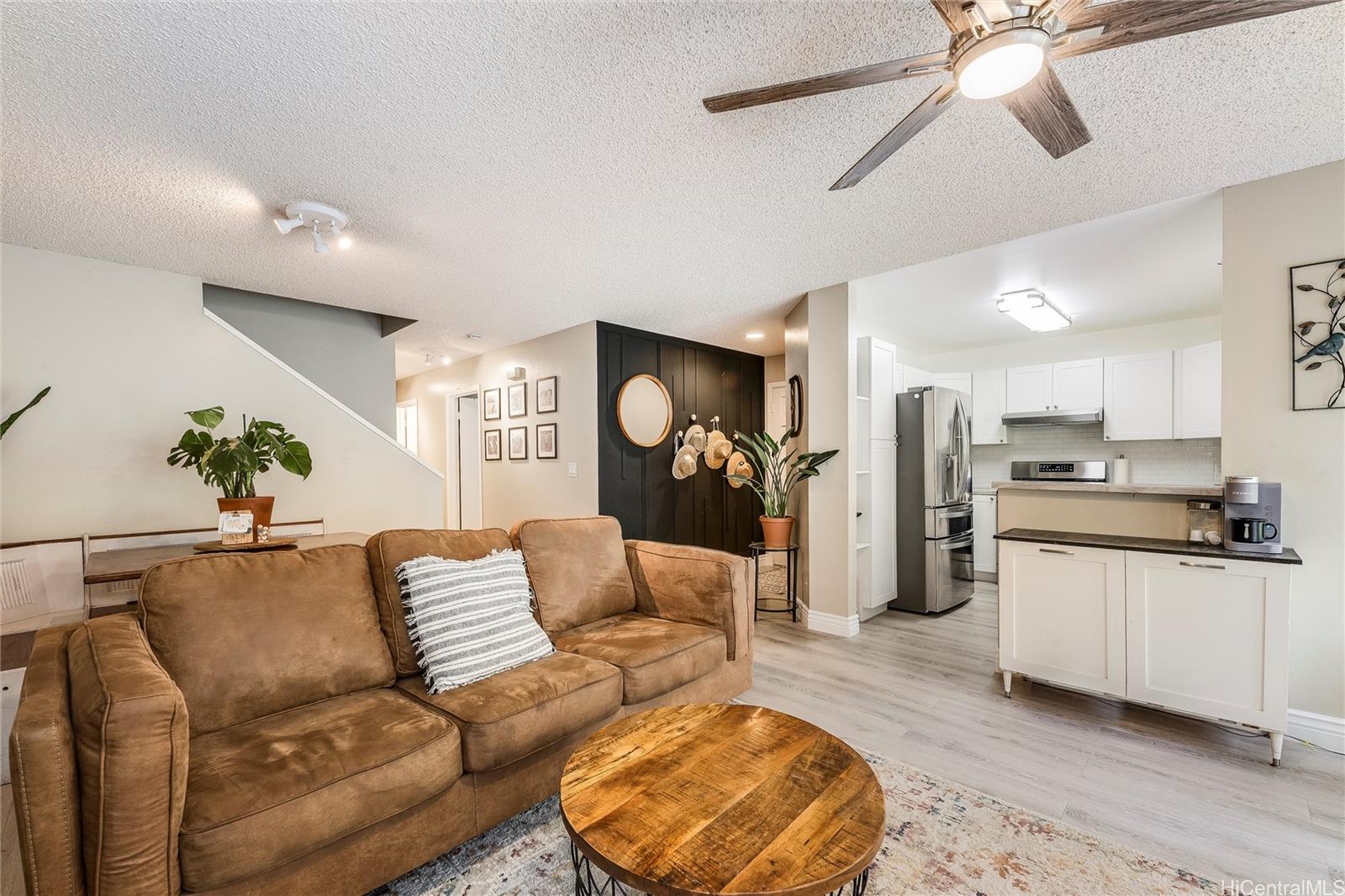 a living room with furniture and kitchen view