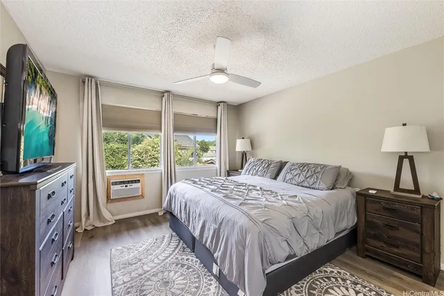 a spacious bedroom with a large bed and a chandelier