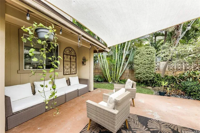 a view of a patio with couches and potted plants