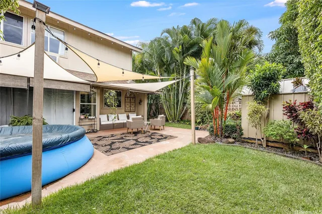 a view of a house with backyard porch and sitting area