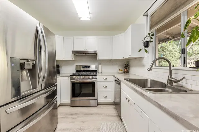 a kitchen with a sink stove and refrigerator