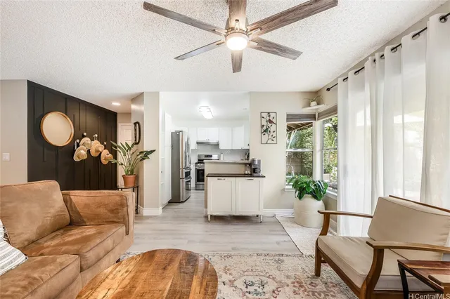 a living room with furniture a chandelier and a dining table