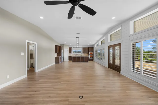 a bathroom with a granite countertop sink a toilet and a shower