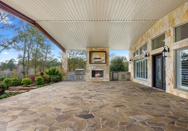 a front view of a building with a yard and potted plants