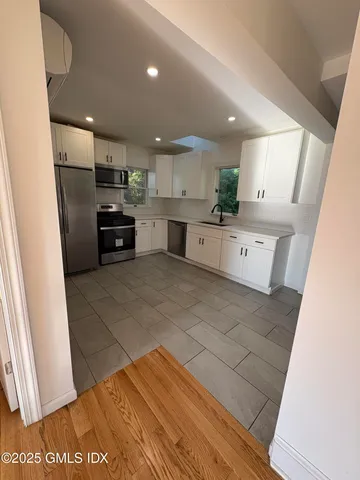a kitchen with refrigerator and cabinets