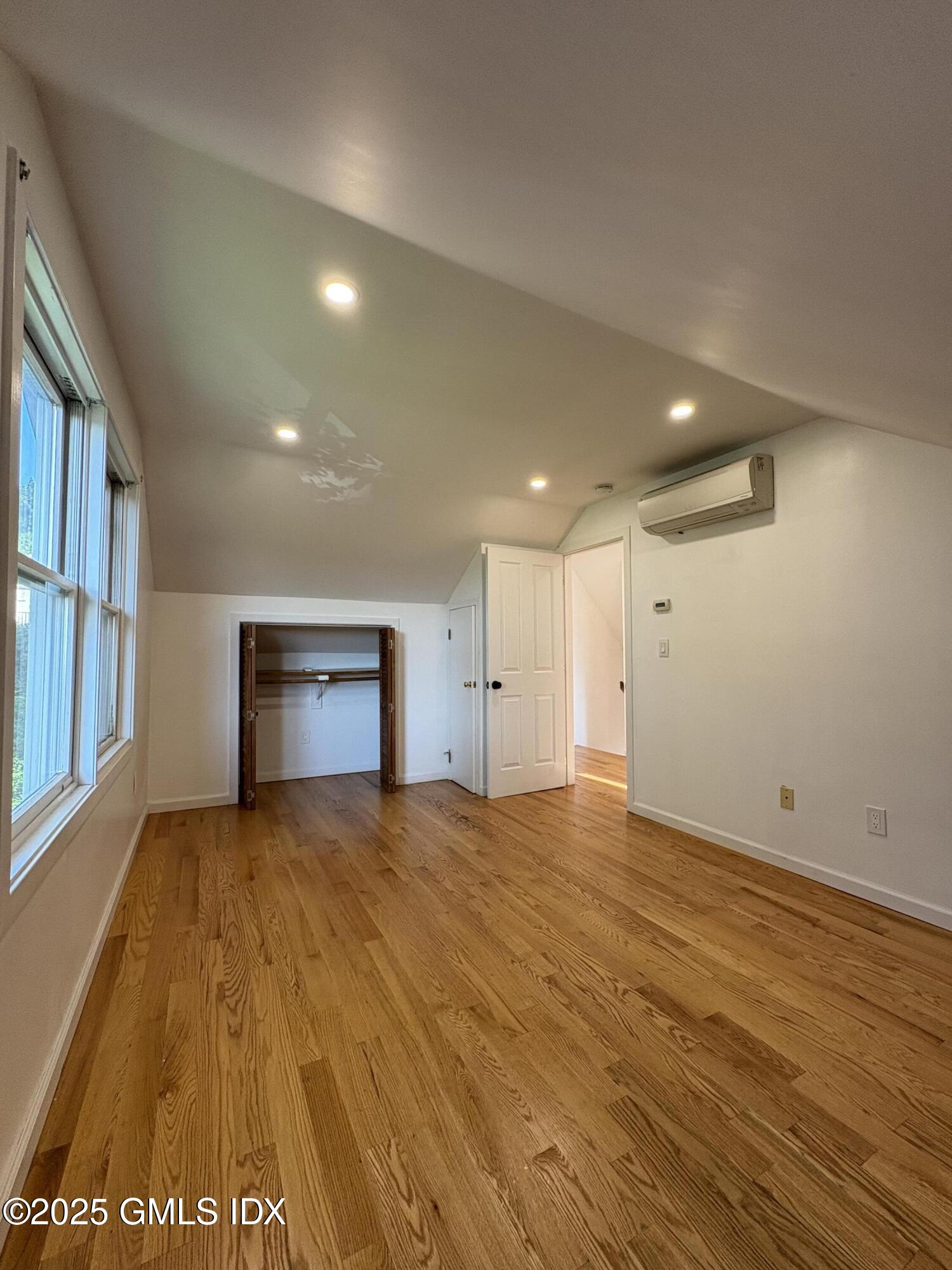 119 North Water Street, Unit A Greenwich, CT 06830 - Photo 4 of 7 a view of an empty room with wooden floor and a window
