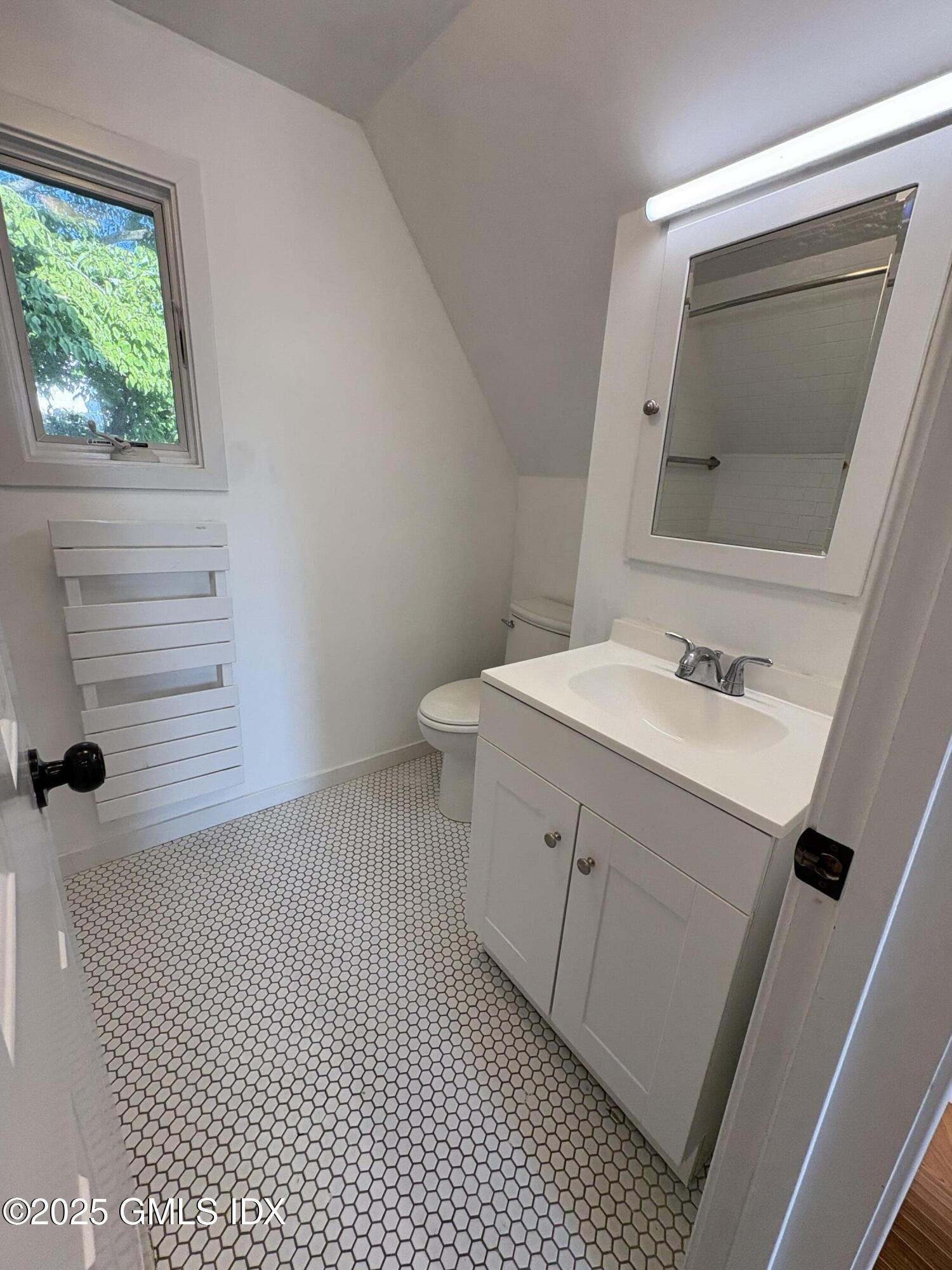 119 North Water Street, Unit A Greenwich, CT 06830 - Photo 7 of 7 a bathroom with a sink vanity and toilet