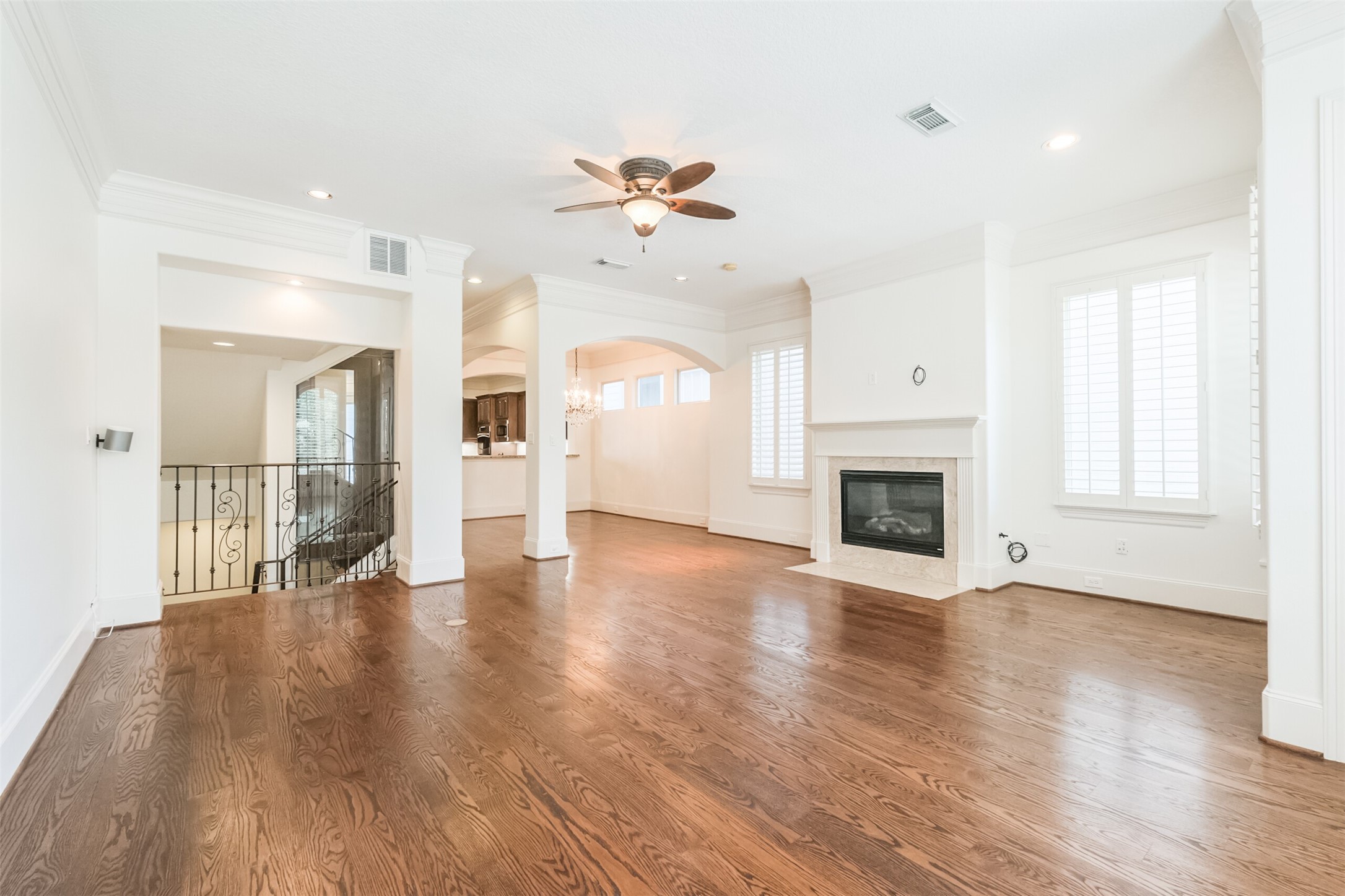 407 West Bell Street Houston, TX 77019 - Photo 16 of 49 a view of a livingroom with wooden floor a fireplace and window
