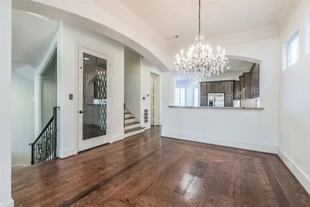 a kitchen with stainless steel appliances granite countertop hardwood floor sink stove and wooden cabinets
