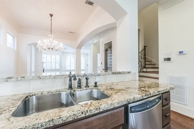 a kitchen with kitchen island granite countertop a sink stove and cabinets