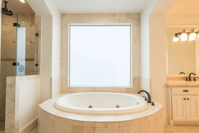a bathroom with a tub and shower