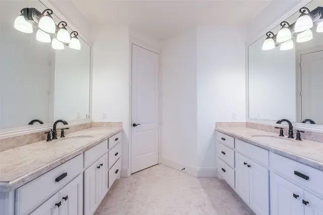 a bathroom with a sink a toilet a shower and mirror