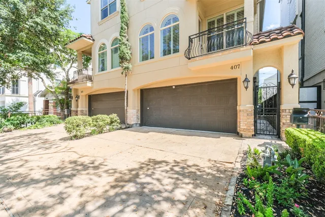 a front view of a building with a yard and trees