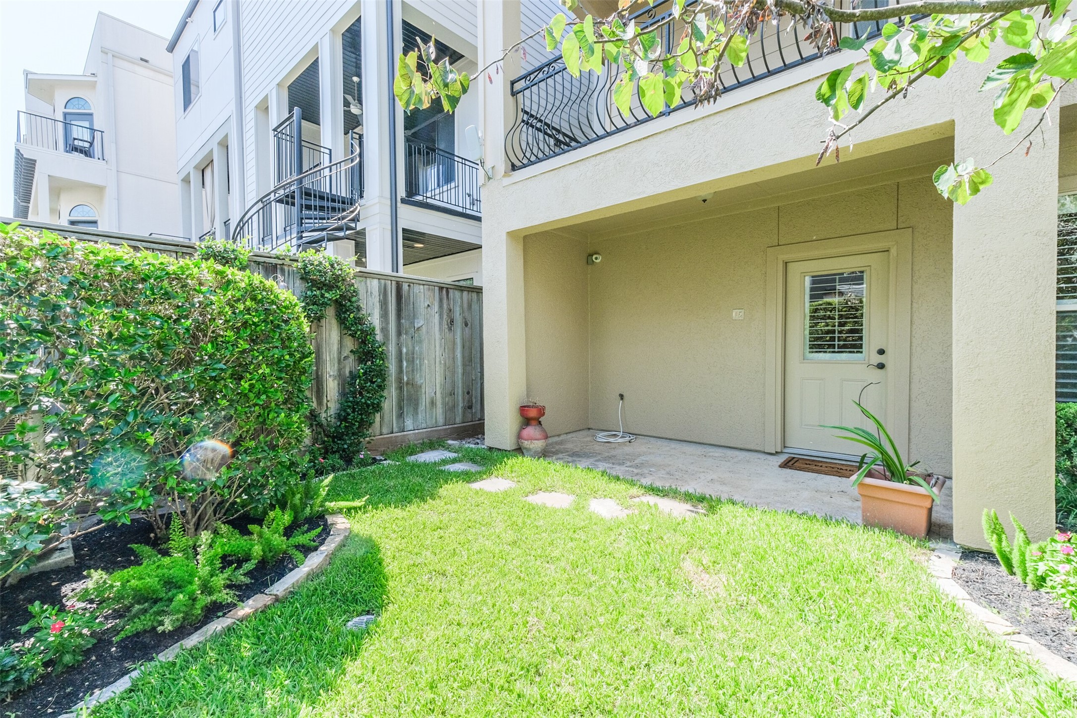 407 West Bell Street Houston, TX 77019 - Photo 49 of 49 a backyard of a house with outdoor seating and plants
