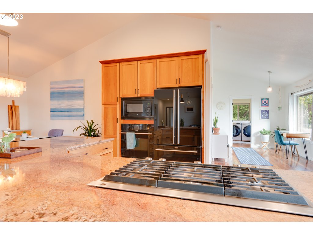 3250 P Street Washougal, WA 98671 - Photo 12 of 48 a living room with furniture stove and a view of kitchen