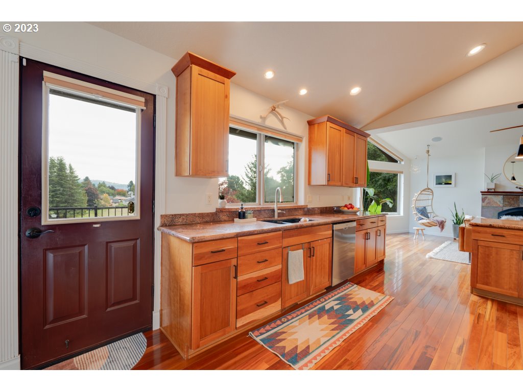 3250 P Street Washougal, WA 98671 - Photo 13 of 48 a large kitchen with granite countertop a large window and stainless steel appliances
