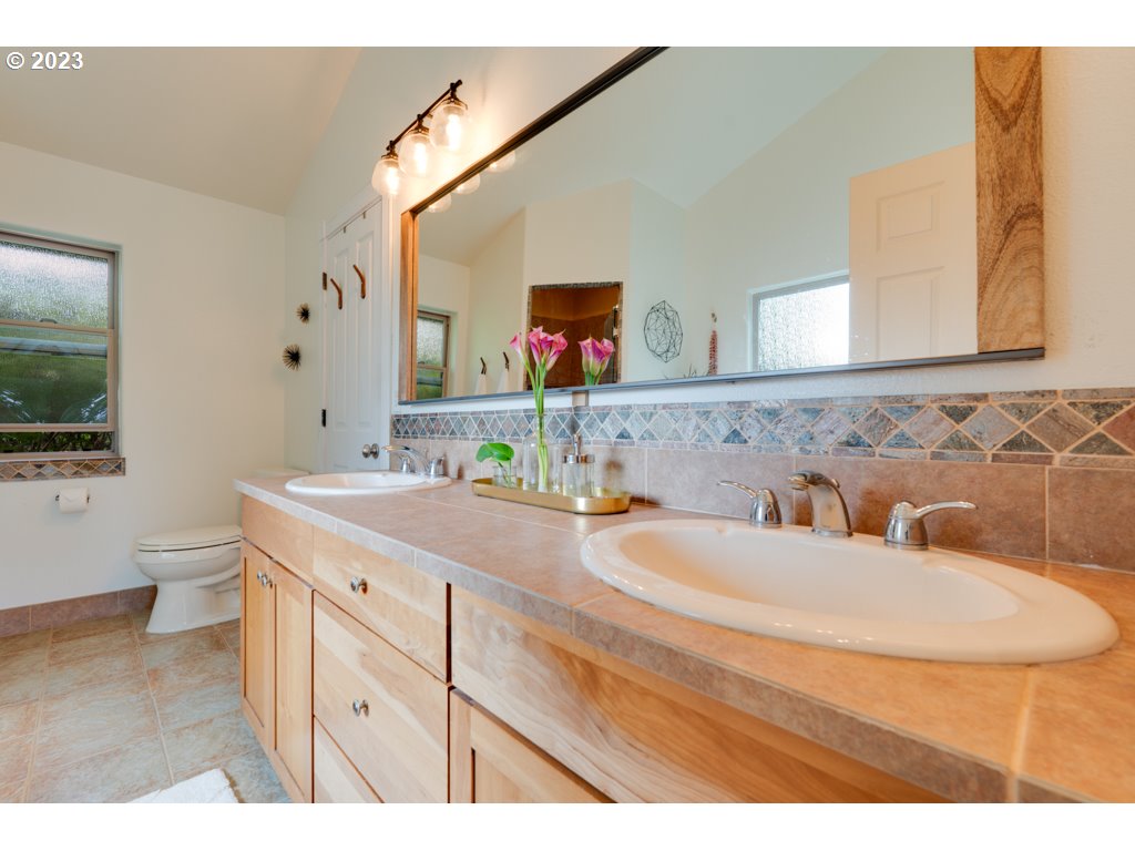 3250 P Street Washougal, WA 98671 - Photo 21 of 48 a bathroom with a granite countertop sink mirror and toilet