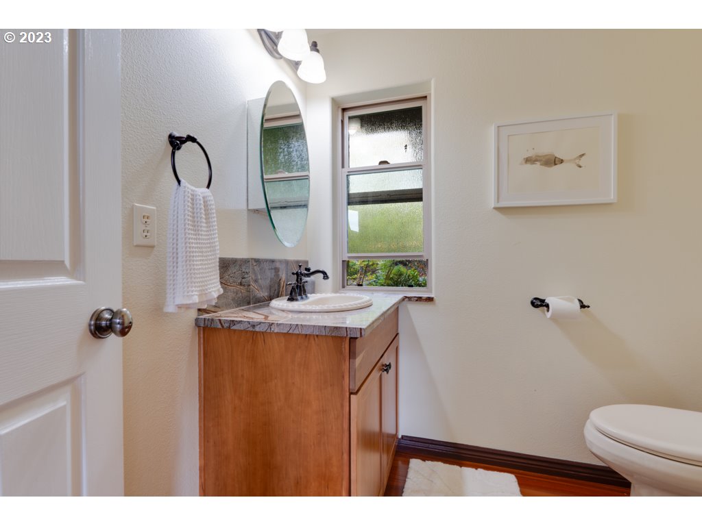 3250 P Street Washougal, WA 98671 - Photo 27 of 48 a bathroom with a toilet sink and mirror