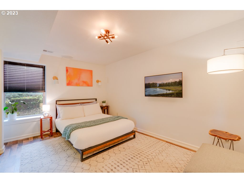 3250 P Street Washougal, WA 98671 - Photo 28 of 48 a bedroom with a bed and a chandelier