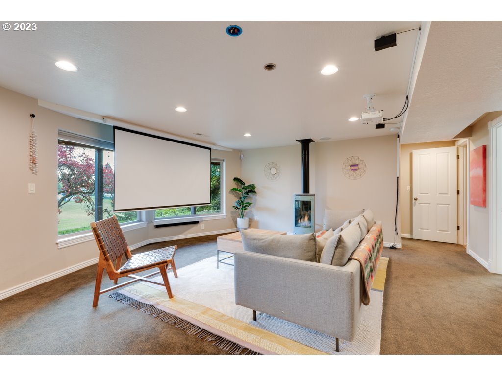 3250 P Street Washougal, WA 98671 - Photo 30 of 48 a living room with furniture a floor to ceiling window and a projector