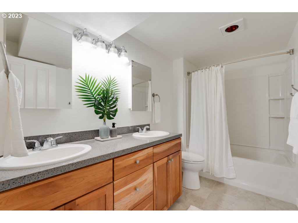 3250 P Street Washougal, WA 98671 - Photo 35 of 48 a bathroom with a granite countertop sink a mirror and a shower