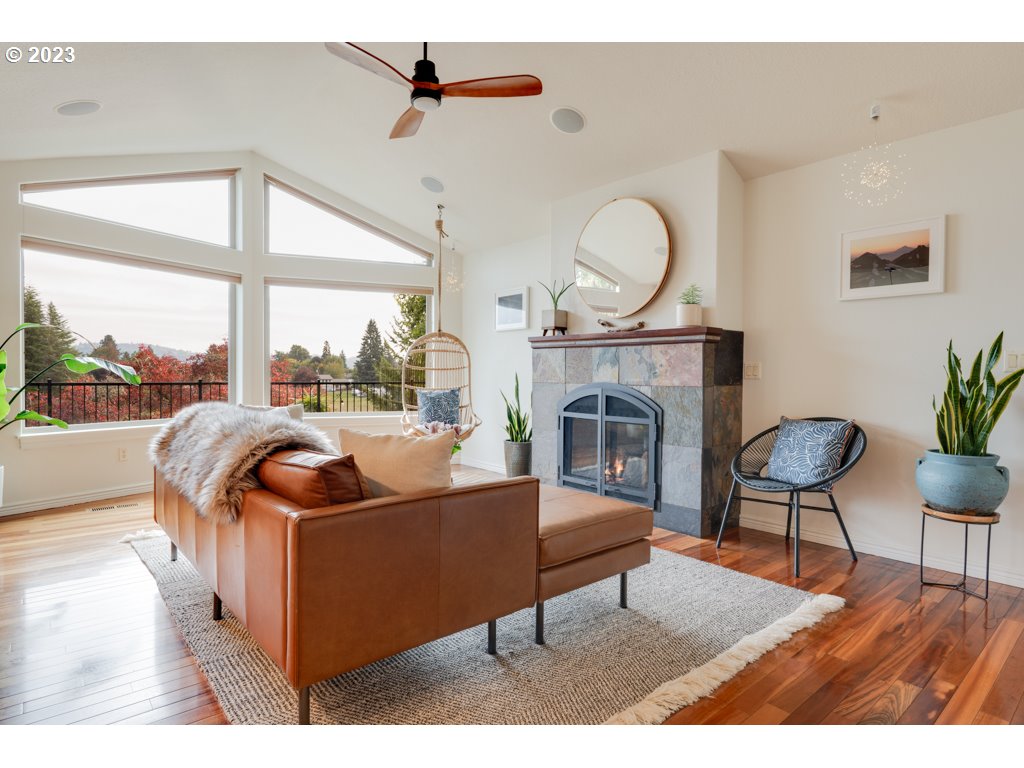 3250 P Street Washougal, WA 98671 - Photo 8 of 48 a living room with furniture a fireplace and a floor to ceiling window