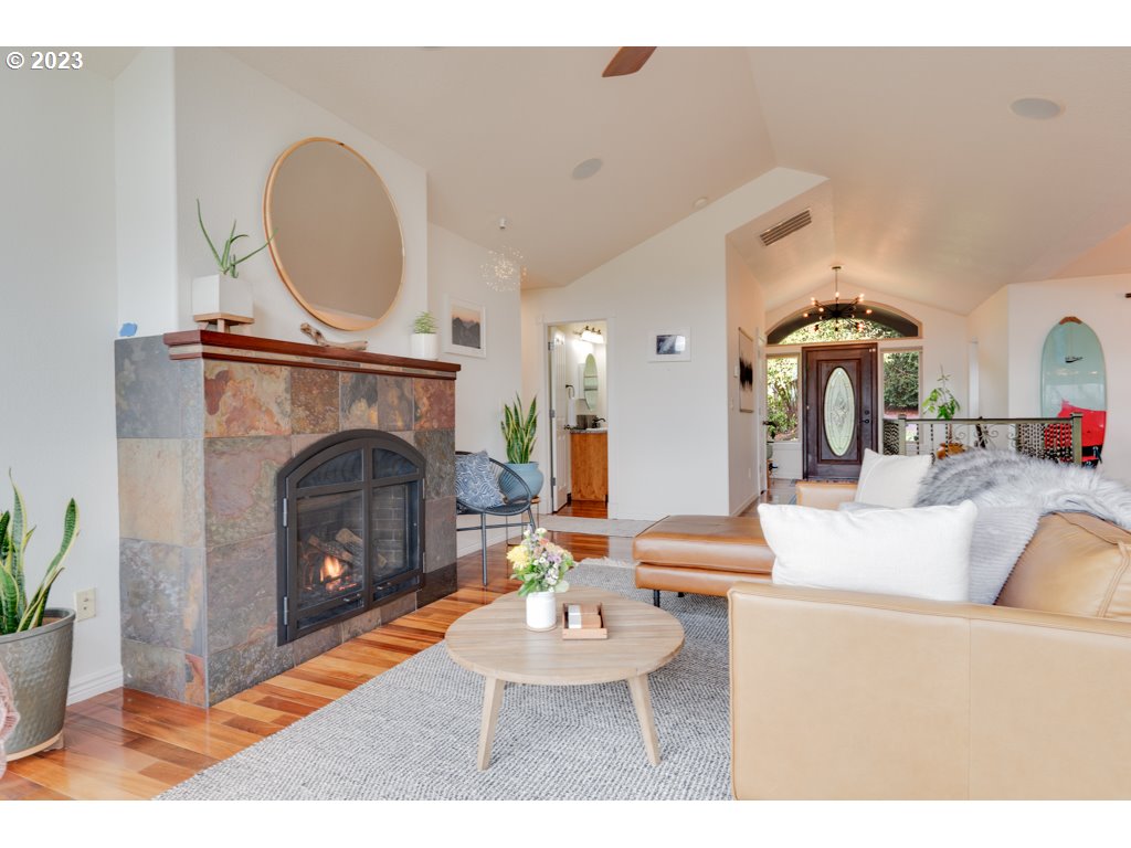 3250 P Street Washougal, WA 98671 - Photo 10 of 48 a living room with furniture a fireplace and a potted plant