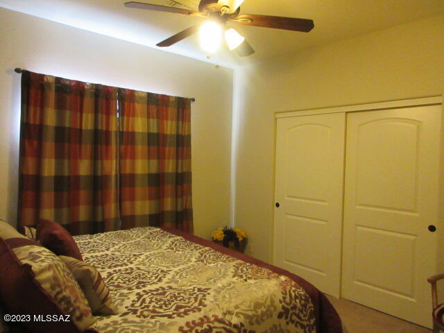 511 Camino Hombre De Oro Rio Rico, AZ 85648 - Photo 42 of 44 a bedroom with a bed and a chandelier