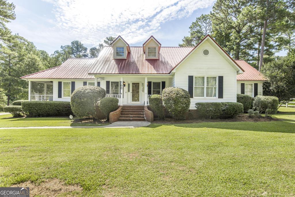 168 Woodland Heights Road Dublin, GA 31021 - Photo 1 of 1 a front view of a house with a garden