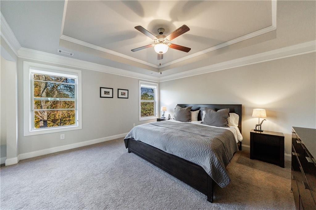 2002 Raven Way Atlanta, GA 30341 - Photo 6 of 27 a spacious bedroom with a bed and a chandelier