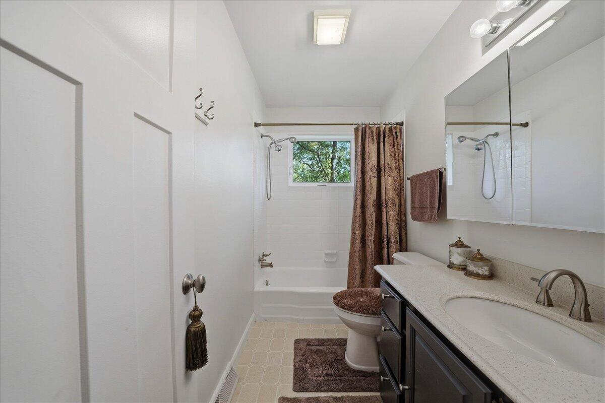 63 Ski Hill Road Portage, IN 46368 - Photo 16 of 28 a bathroom with a sink toilet double vanity and tub