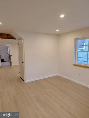 a view of a livingroom with wooden floor and stairs