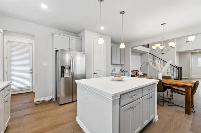 a kitchen with a sink a counter and stainless steel appliances