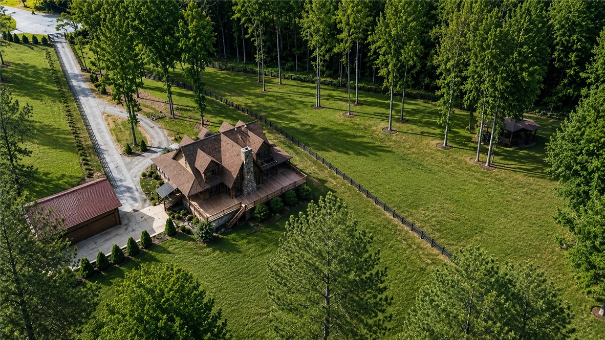 414 Devon Way Anderson, SC 29621 - Photo 49 of 50 Overlooking expansive grounds, this secluded estate boasts a large private deck and a charming gazebo amidst a lush, wooded landscape.