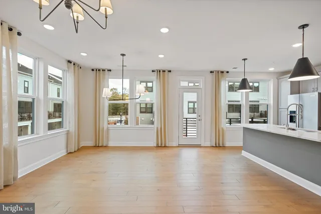 a view of an empty room with window and cabinet
