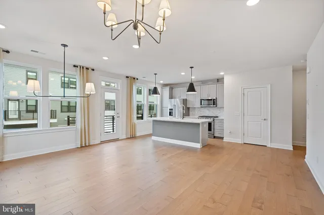 a large kitchen with stainless steel appliances kitchen island a large counter top and stainless steel appliances