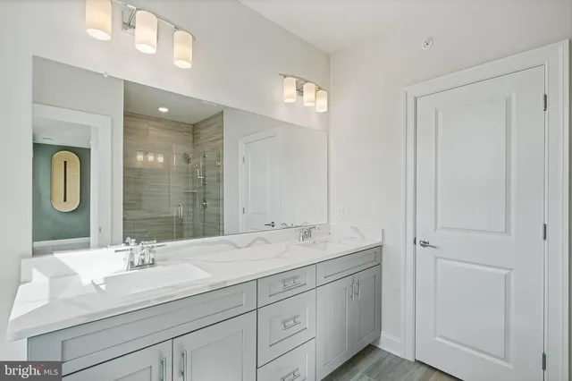 a bathroom with a double vanity sink and a mirror